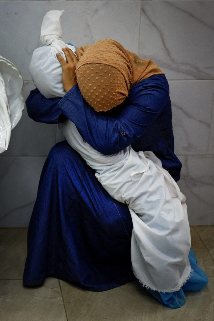 Palestinian woman embraces the body of her niece Mohammed Salem